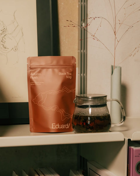 Pouch of Autumn Flush on a shelf next to a glass teapot
