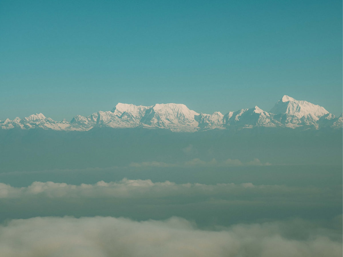 Snow-capped Himalayan peaks above the clouds