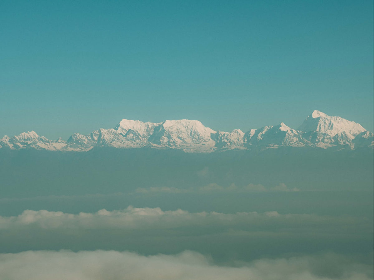 Snow-capped Himalayan peaks above the clouds