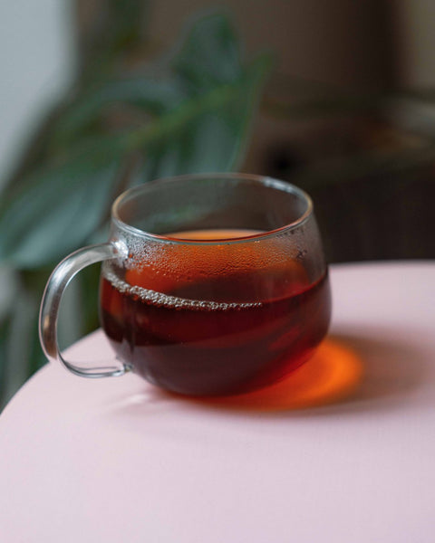 Glass cup of black tea from Nepal