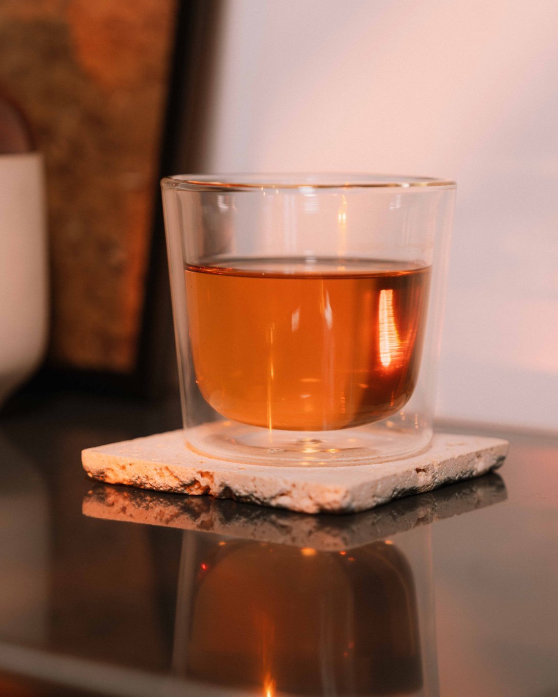 Glass of black tea from Nepal on a stone coaster