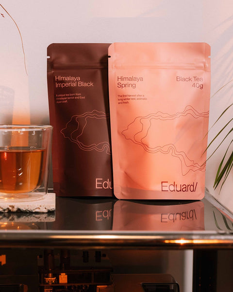 Nepal Selection pouches next to a glass of tea