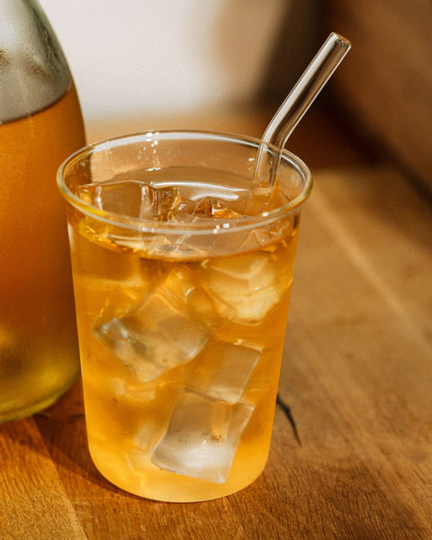 Glass of Wulong Suka over ice with a straw